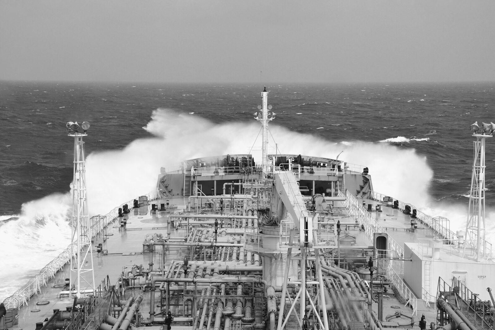 Ship's bow plowing through heavy seas in bad weather